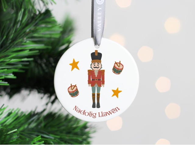 White ceramic christmas tree decoration with the image of a cute nutcracker soldier 2